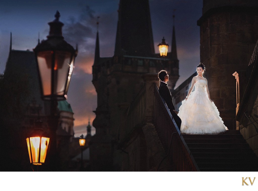 Stylish bride & groom at sunset atop the Charles Bridge