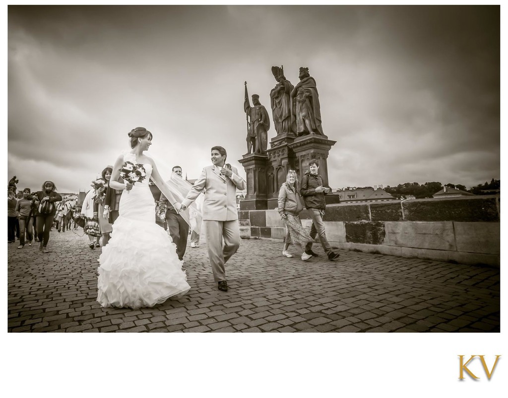 Two Brides Walking Across Charles Bridge