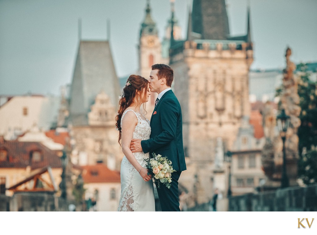 loving embrace atop Charles Bridge