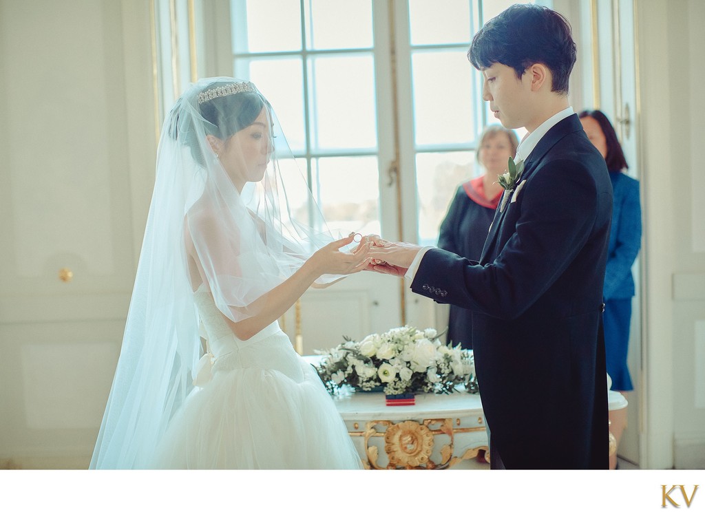 Bride places ring on finger