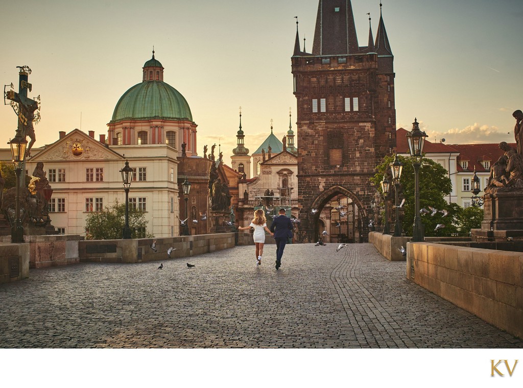 running through pigeons atop Charles Bridge