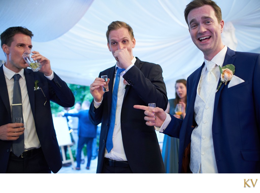 Groom and his best men enjoy a drink at the Villa Richter in Prague