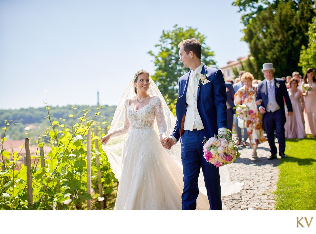 newlyweds walk through vineyards at Villa Richter