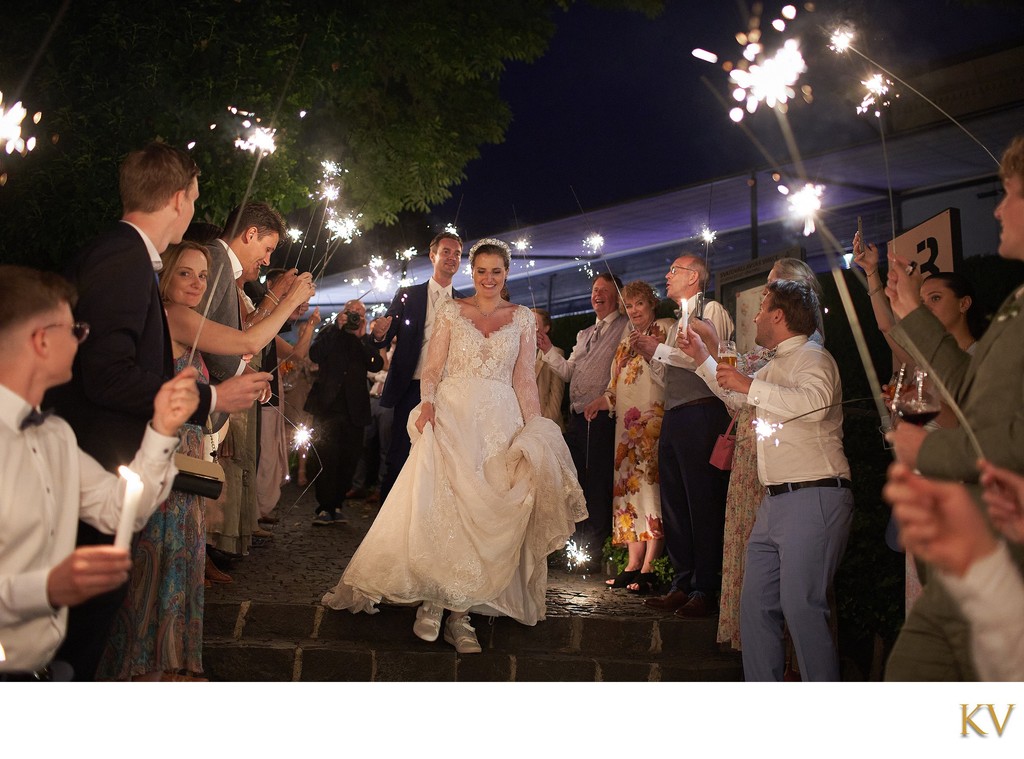 Well-wishers salute the bride & groom with sparklers