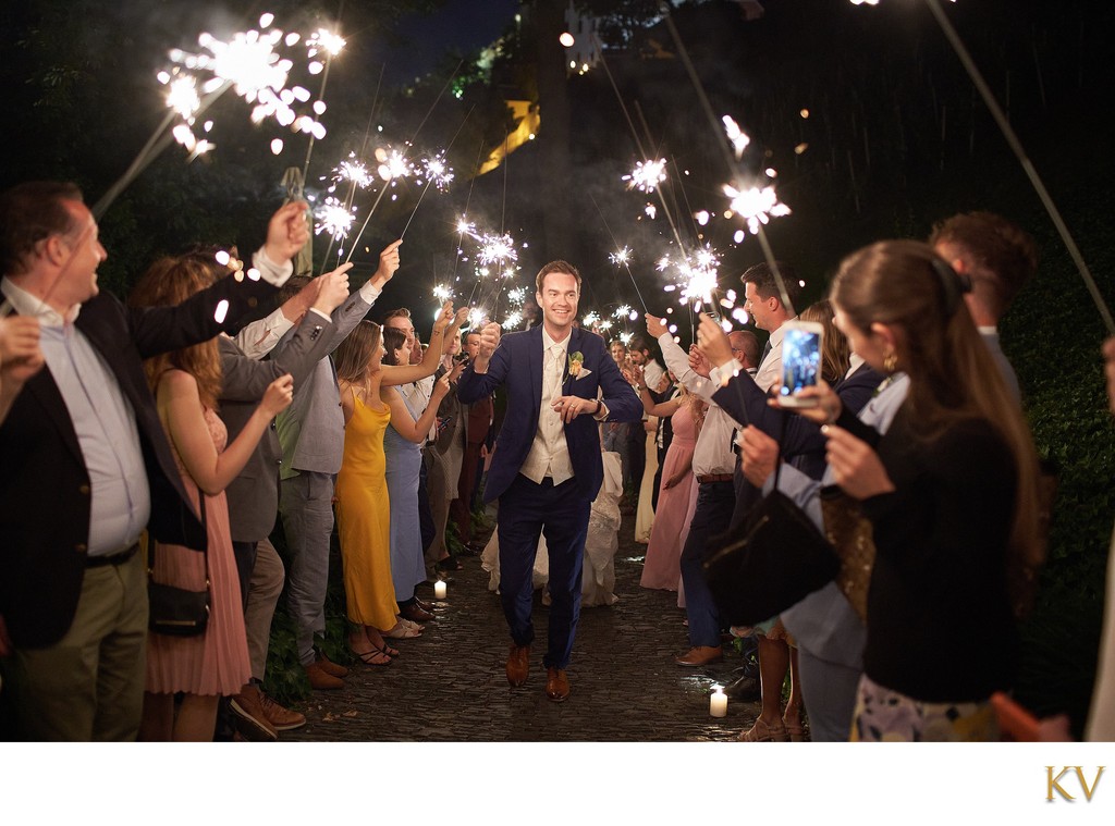 The beaming Groom is saluted with sparklers at the Villa Richter