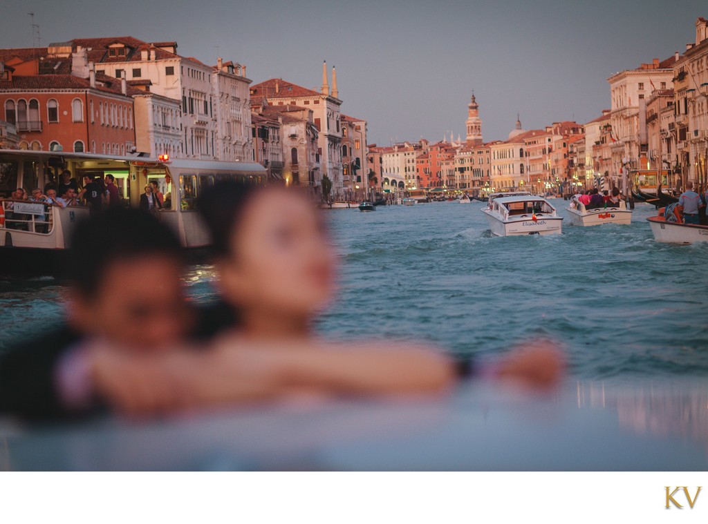 Thai couple enjoying a private boat ride in Venice at twilight