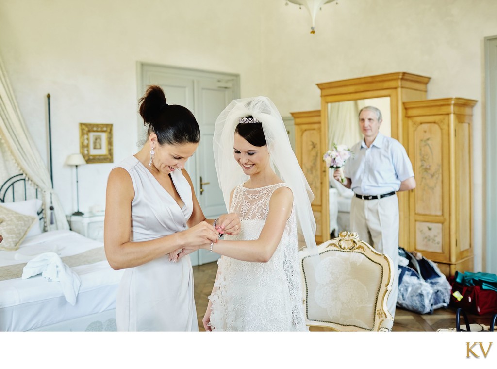 Smiling bride as bracelet is put on