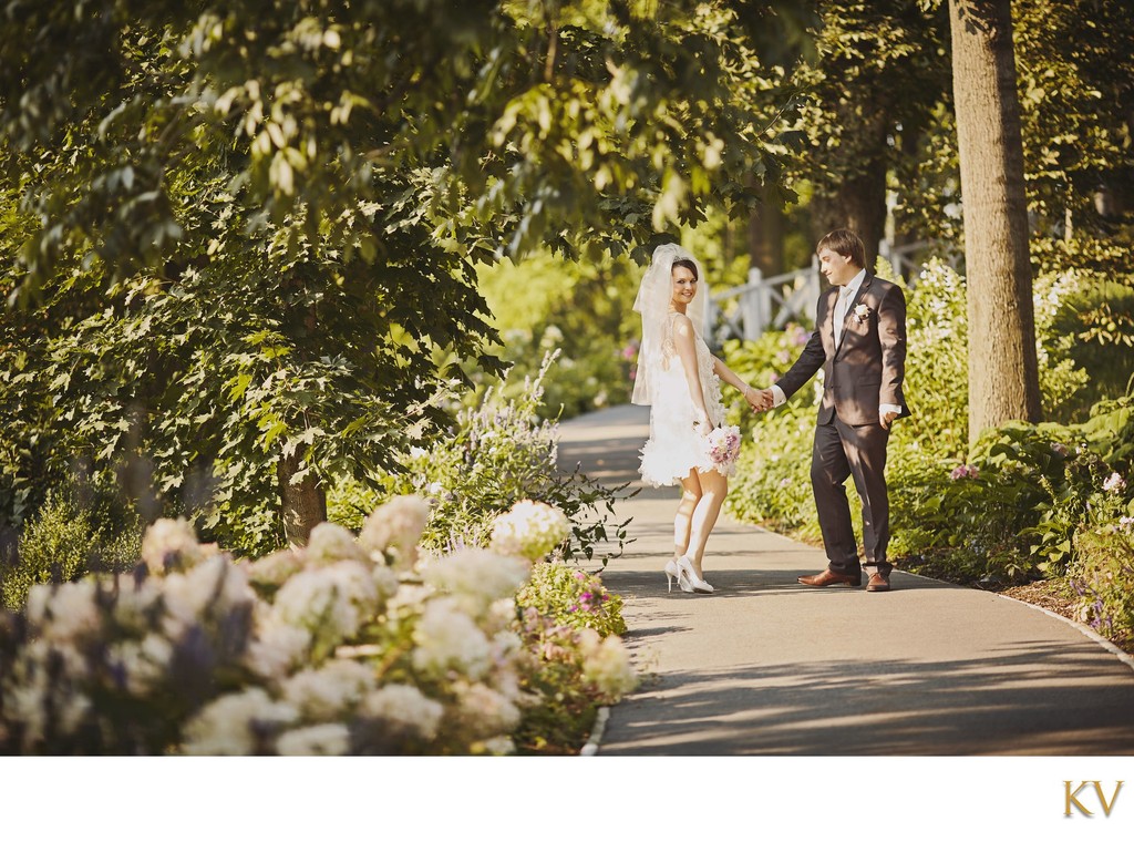 Newlyweds Along Flower-lined path