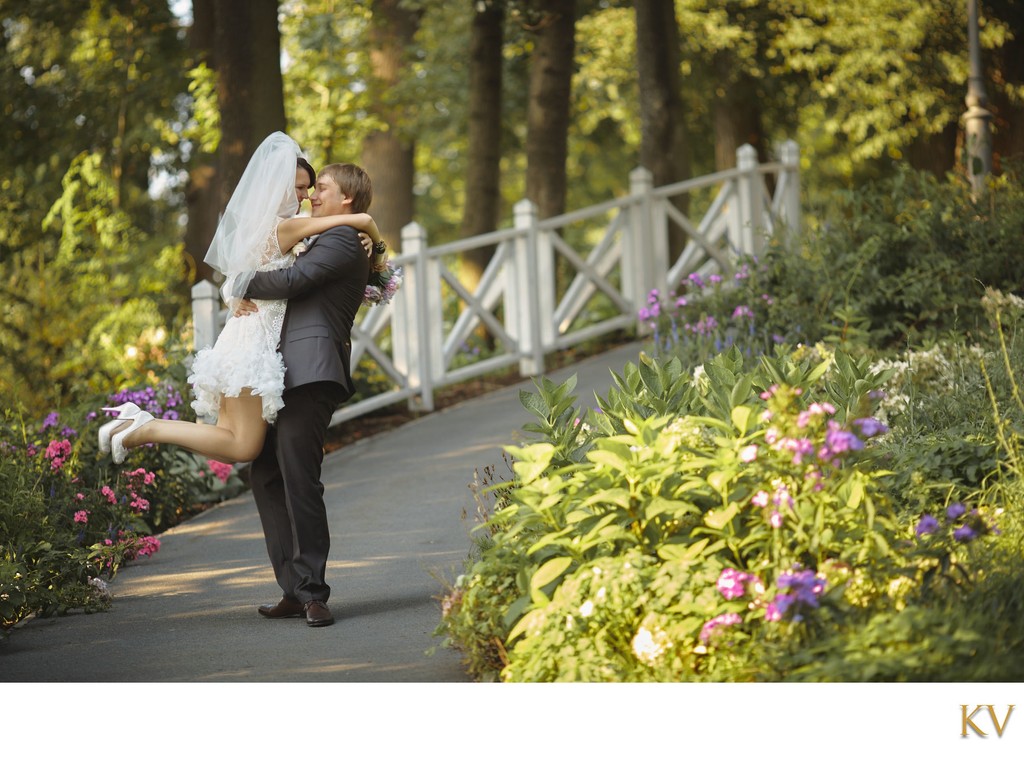 Groom kissing bride amid garden