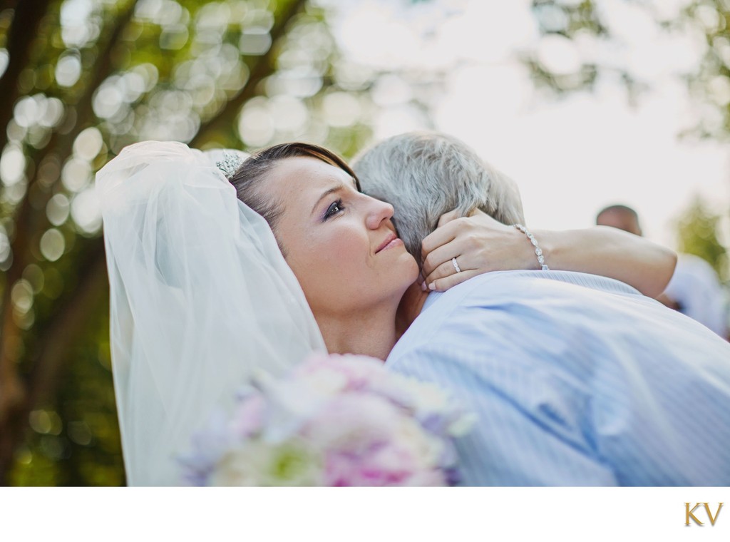 tearful bride embracing father