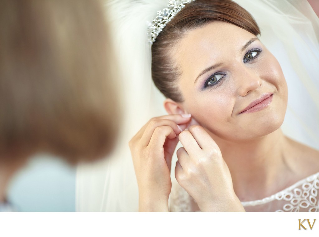 Bride putting on earring