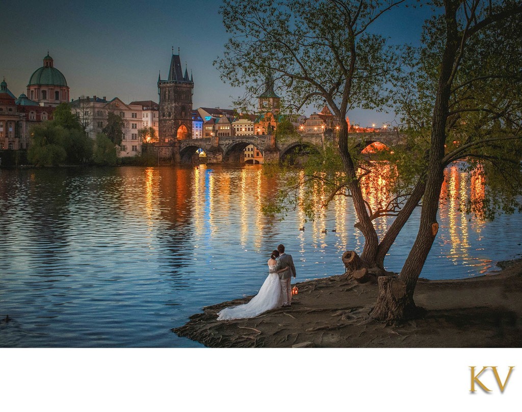 Newlyweds watch the sunrise over Charles Bridge