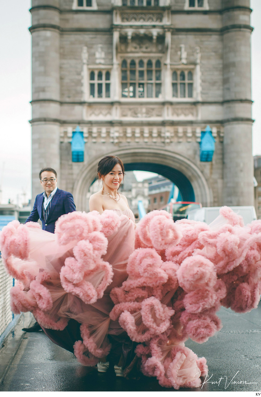 Woman in Pink Dress walking on London Tower Bridge