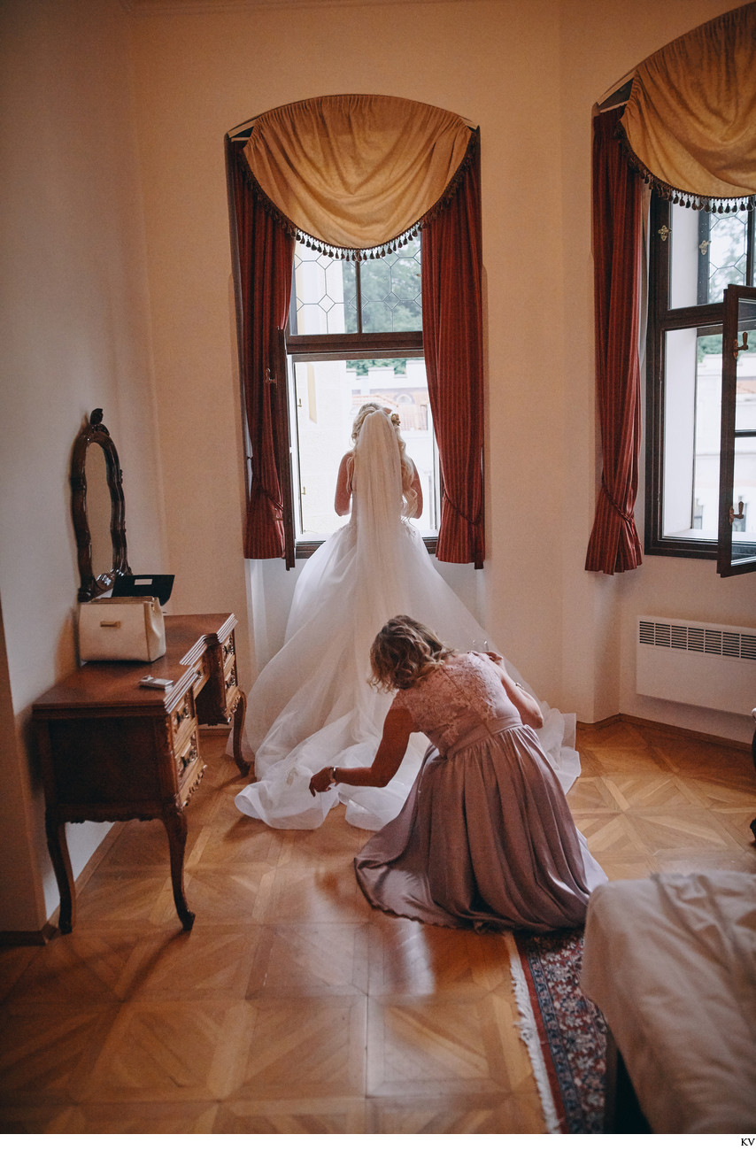 Bride's mother adjusts her dress