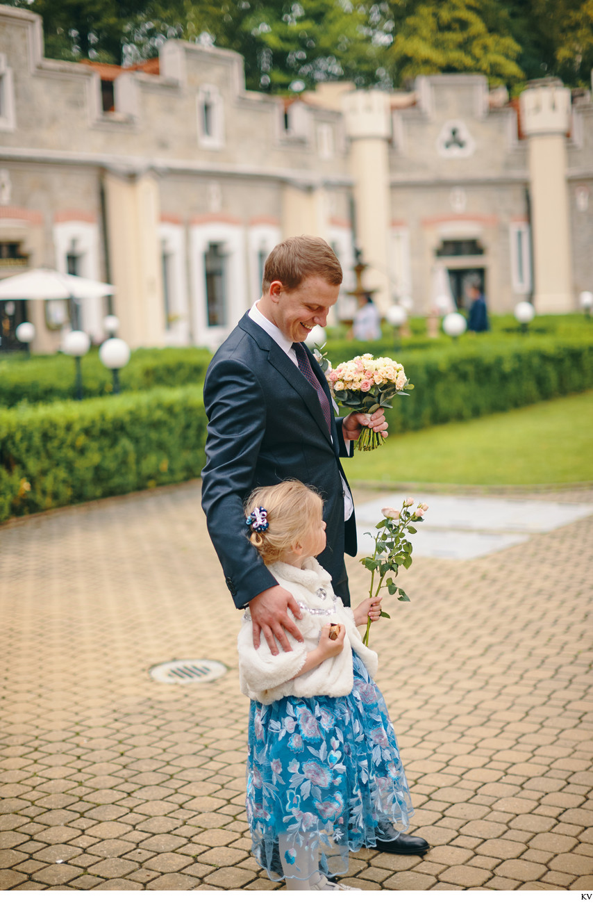 groom awaits with flower girl