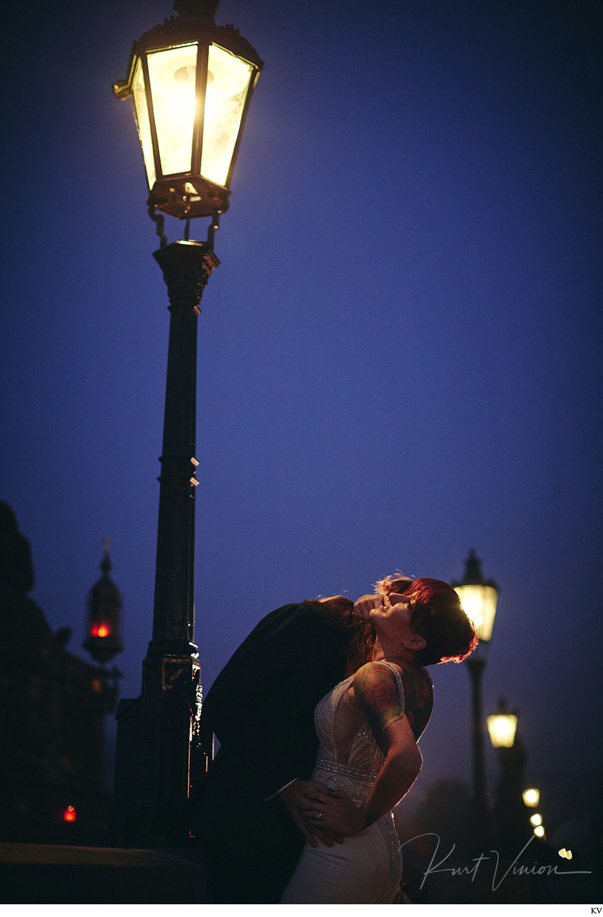 Sexy kiss under gas lamps Prague Charles Bridge