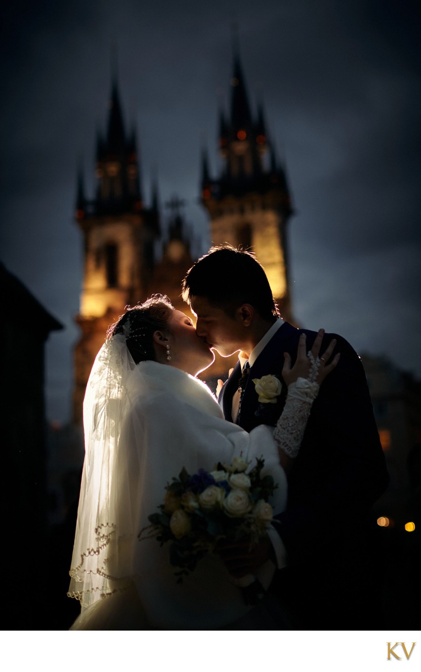 Russian bride & groom kissing in Prague's  Old Town