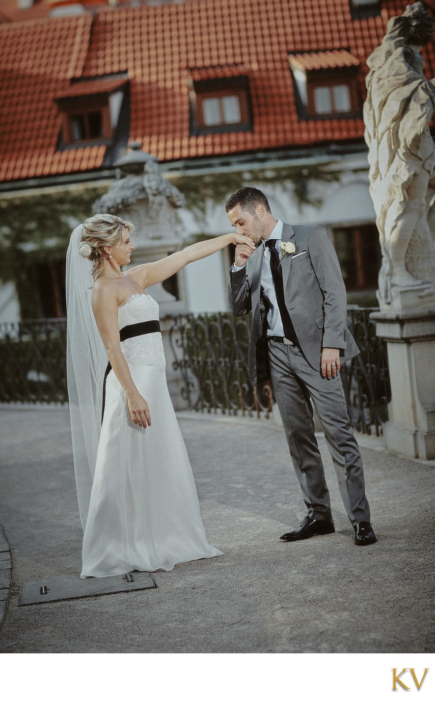 kissing his brides hand at the Vrtba Garden 