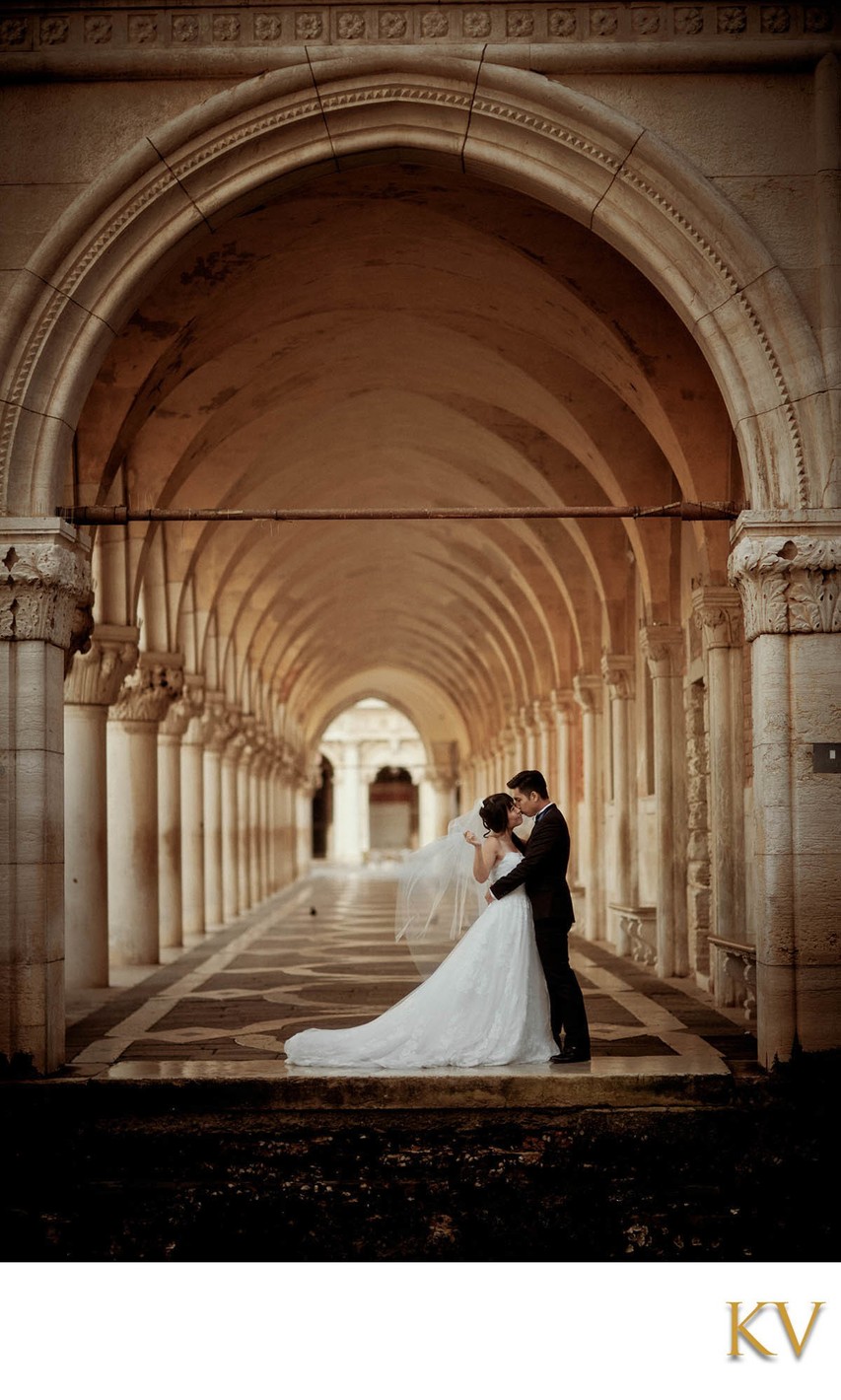 embracing under the portico of the Doge's Palace