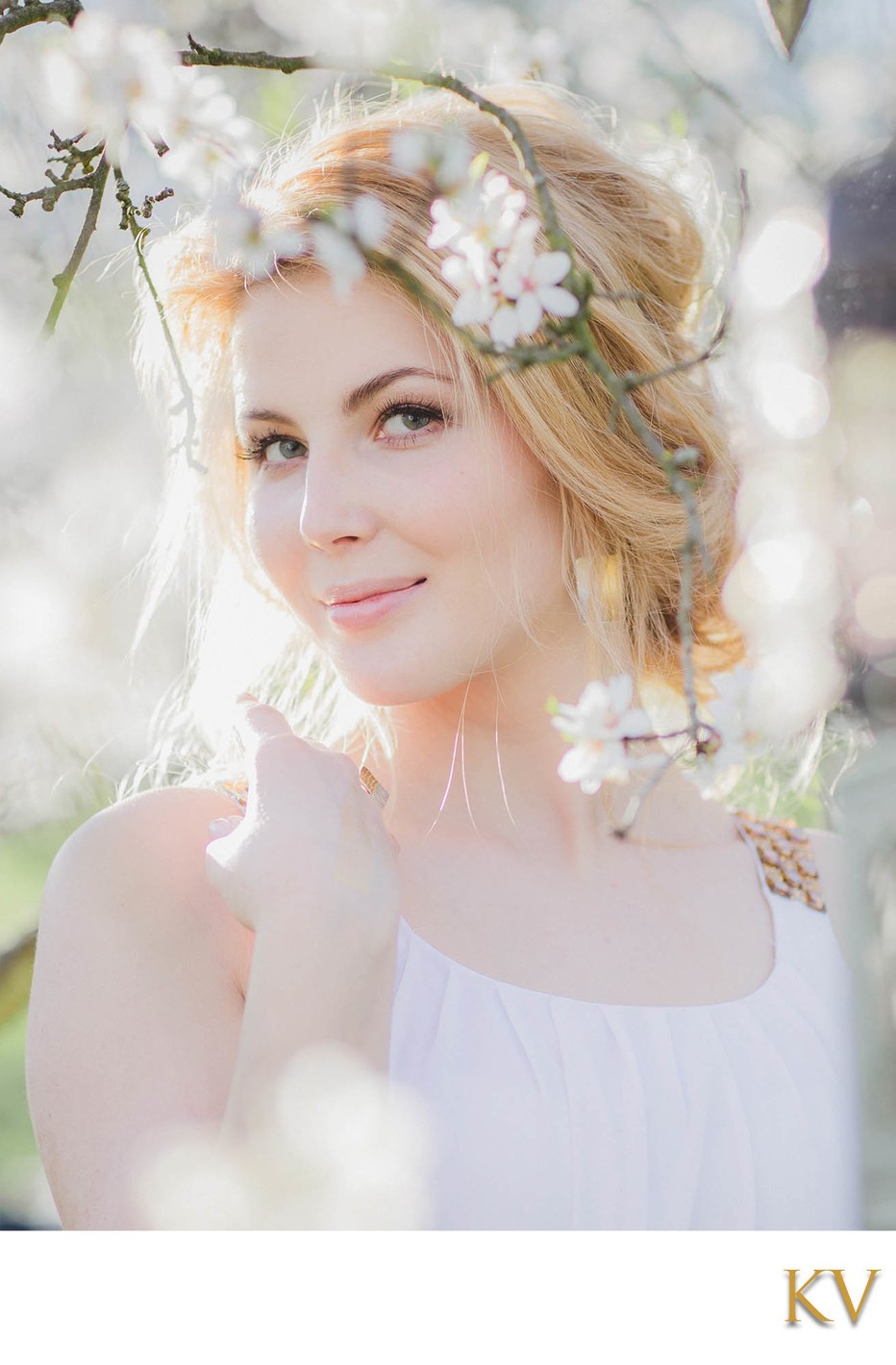 beautiful sun flared blonde amid the Cherry Blossoms