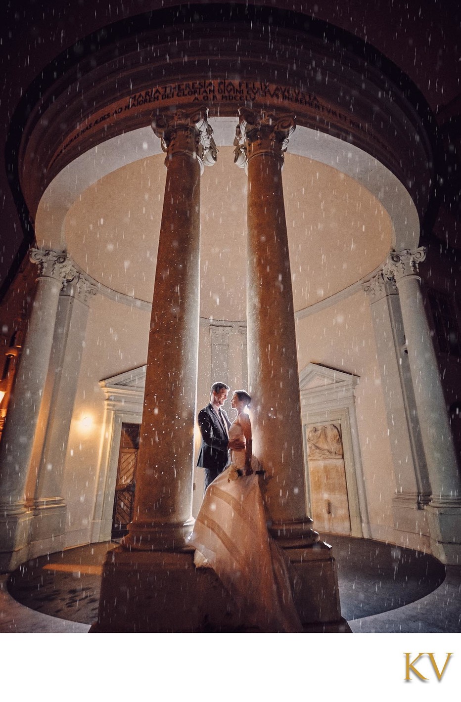 Newlyweds in the rain at Prague Castle at midnight