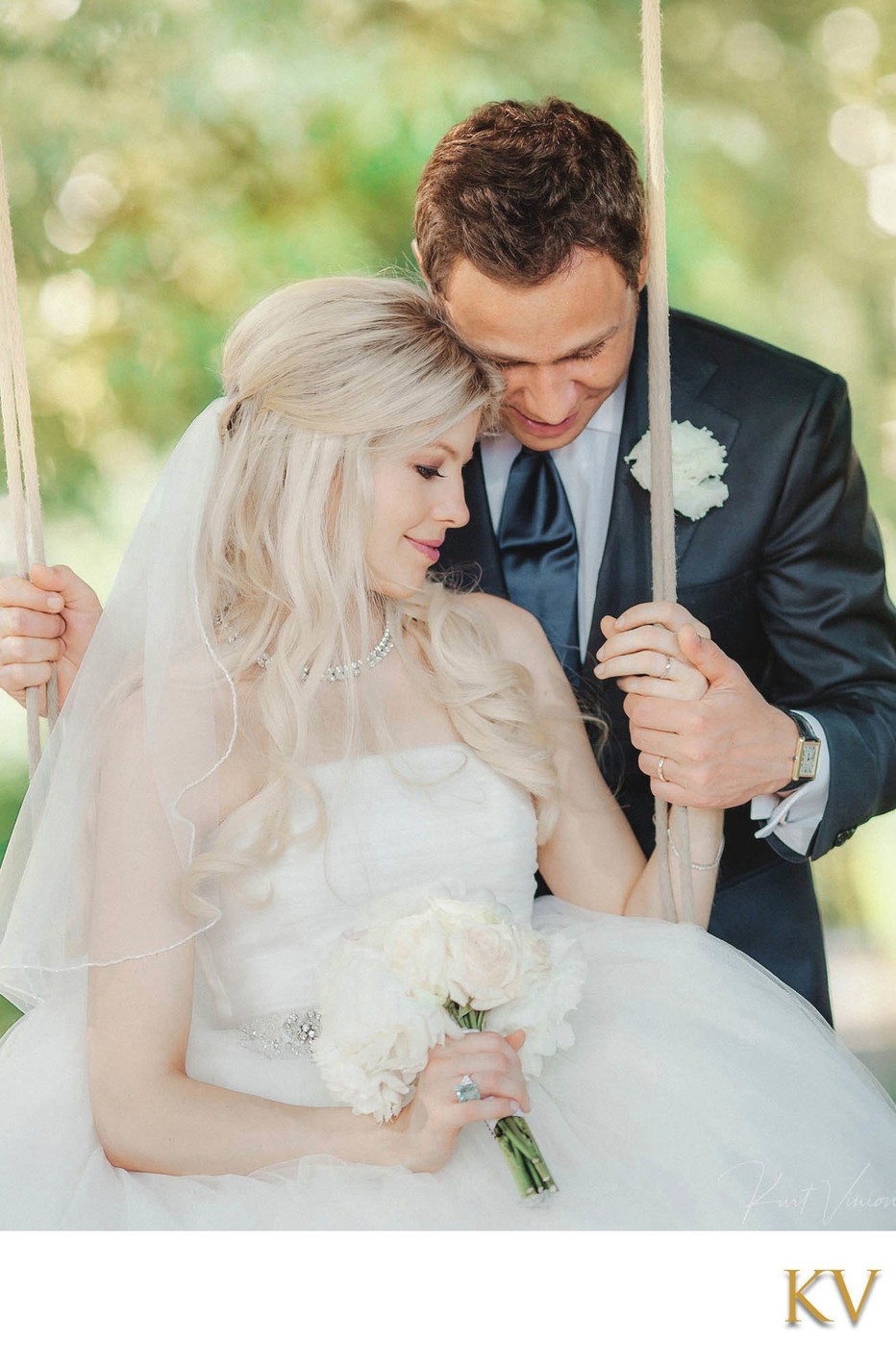 Newlyweds enjoy private moment as bride sits on swing