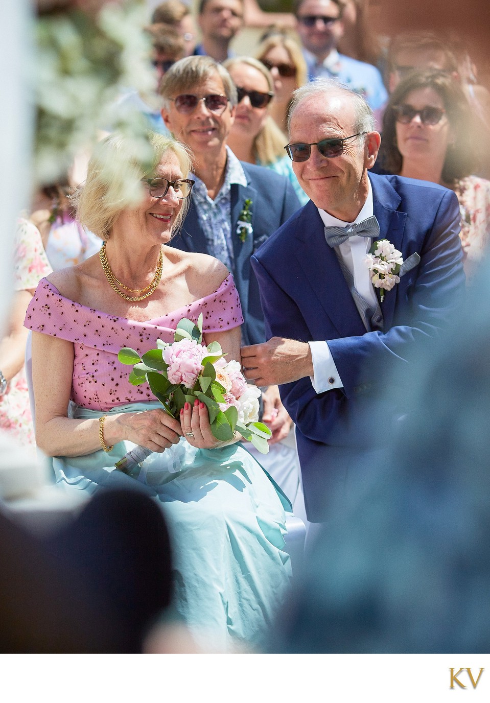 happy parents watching their son marry