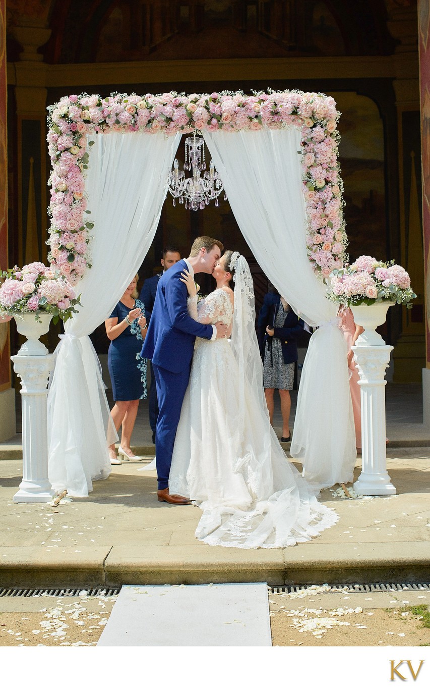 Newlyweds Kiss under Chandelier