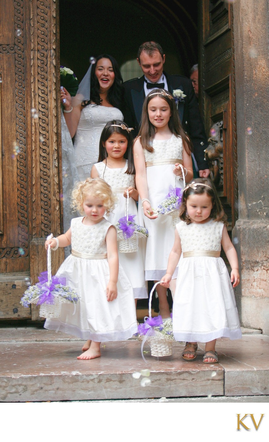 Barefoot flower girl throwing rose petals Prague