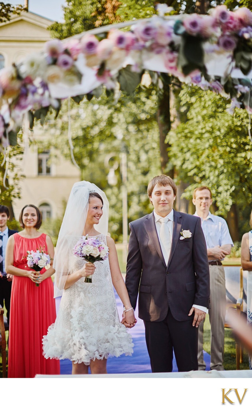 bride smiles towards groom