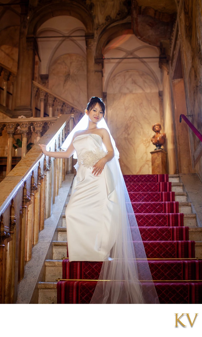 Bride sauntering down steps in Hotel Danieli