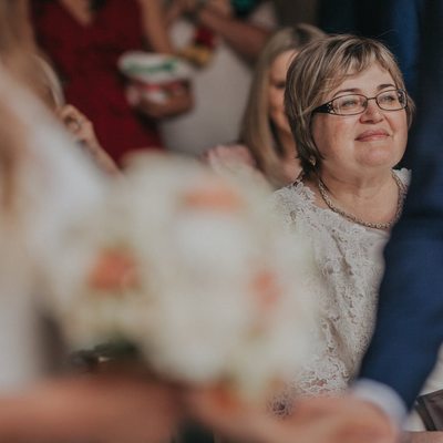 the proud mother watches the wedding ceremony