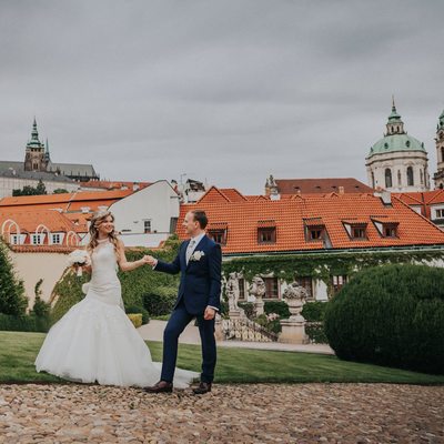 Bride & Groom walk with Prague Castle in background 
