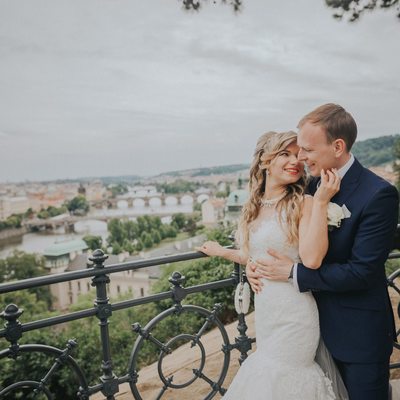 moment shared between bride & groom above Prague