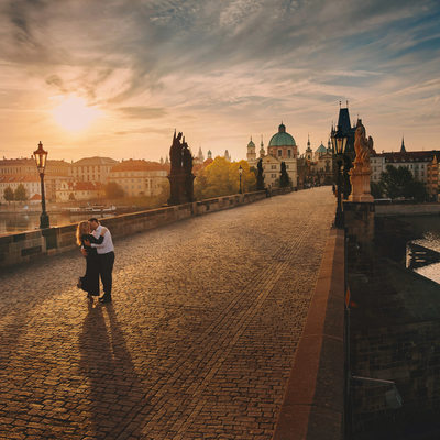 Fine art photo romantic couple embracing Prague sunrise