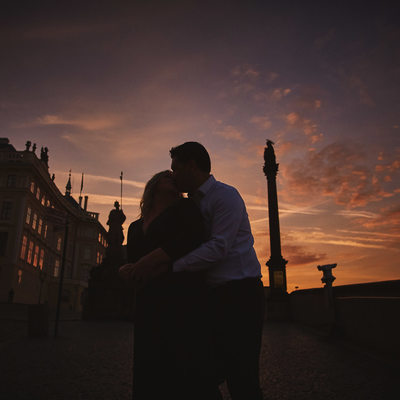 Christie & Michael snuggle at Prague Castle at sunrise