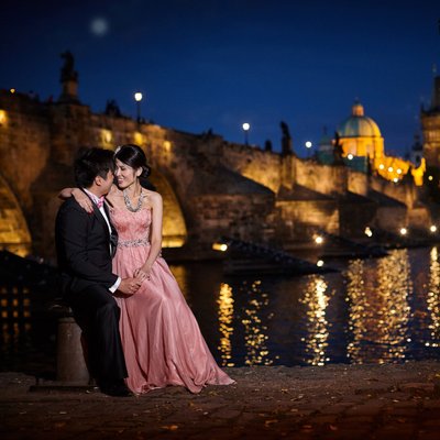 elegant couple enjoying moment Charles Bridge nite