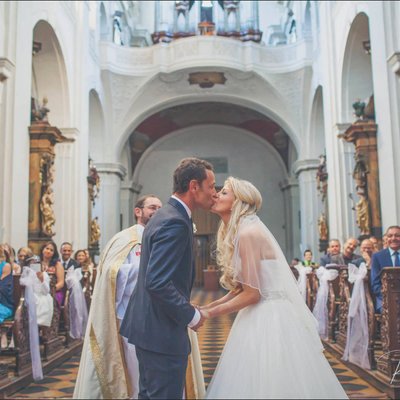 bride & groom kiss Church of St. Thomas Prague wedding