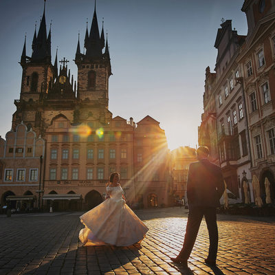 Newlyweds celebrating in Old Town Square at sunrise