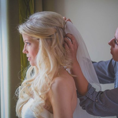 putting on the brides veil Augustine weddings Prague 