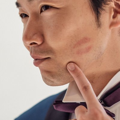 Groom showing off his brides kiss on his cheek