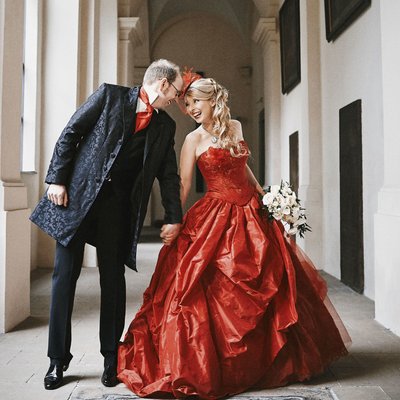 Joyful moment bride in red and groom St. Thomas Prague