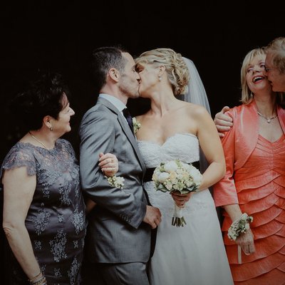 Newlyweds kiss as parents react