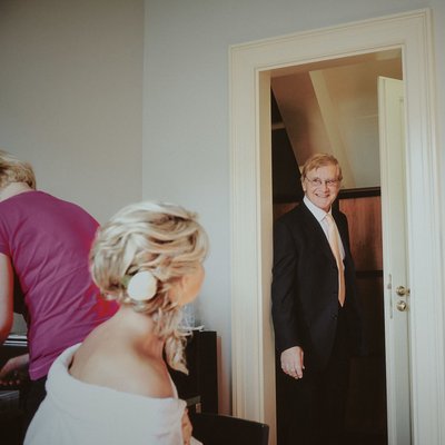 Father of bride checking on daughter on wedding day