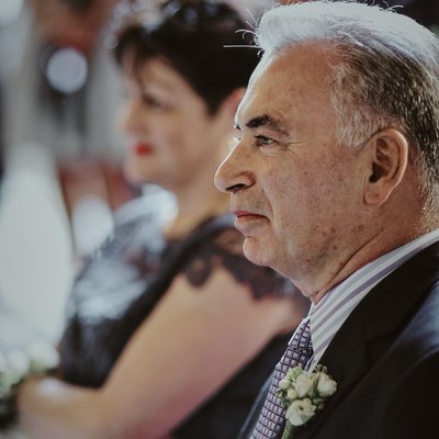 grooms father watches his son marry at  Vrtba garden