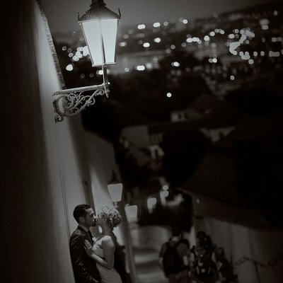 B&W night time portrait of bride & groom under gas lamps