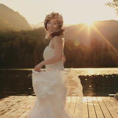 bride twirling her wedding dress Golden Light Lake Bled