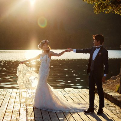 Holding his brides hand  Golden Light of Lake Bled
