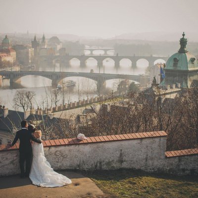 Elegant bride & groom enjoying panoramic view of Prague