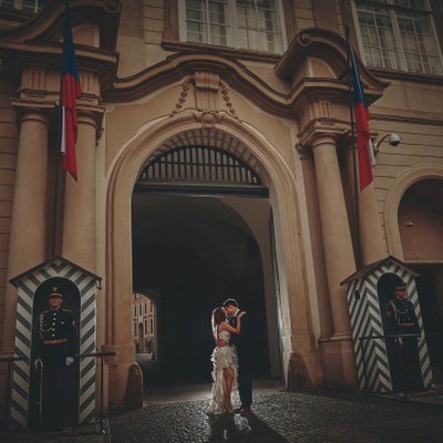 castle guards stand watch as bride & groom kiss